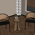 Modern Interior Space Featuring Wicker Chairs Small Round Table Potted Plant And Floor Lamp