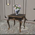 Elegant Dark Wood Side Table With Golden Carved Legs And Floral Vase On Patterned Rug