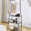 Stylish Multi Tiered Clothing Rack With Hanging Clothes Black Handbag Books And Photo Frame