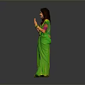 Smiling Woman In Green Sari With Folded Hands On Gray Background