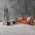 Modern Living Room With Orange Sectional Sofa Throw Pillows Coffee Table And Green Plants