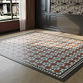 Square Area Rug On Herringbone Wood Floor In Living Room