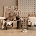 Rattan Leisure Chairs With White Cushions And Blanket By Round Table With Vase And Artwork