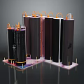 Black Cylindrical Structures With Orange Pipes On Top And Pink Base Supports
