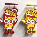 Red And Yellow Milk Tea Cup Cartoon Character Logo With Cute Eyes And Arms