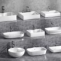 Various White Washbasins With Different Shapes And Faucets On Gray Countertop