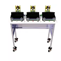 Three Industrial Yellow Black Devices On White Portable Rolling Table Stand