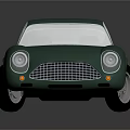 Vintage Green Sports Car With Rounded Body White Headlights And Silver Wheels