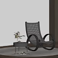 Wicker Rocking Lounge Chair with Small Round Table Plant on Round Rug and Window Blinds