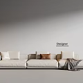 Cream Three Seater Sofa with Cushions Brown Throw Blanket Side Table Lamp and Designer Wall