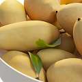 White ceramic bowl filled with fresh ripe mangoes and green leaves