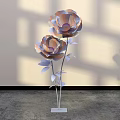 Decorative Floral Installation With Large Flowers Metallic Stems Leaves White Base Light Shadow Background