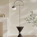 Modern Floor Lamp With Metal Stand Spherical Shade And Conical Base In Light Colored Room