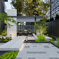 Modern Garden Landscape Featuring Stone Pathway Outdoor Seating Area And Lush Green Plants