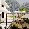 Modern Garden Design With Outdoor Dining Table Umbrella And Green Plants