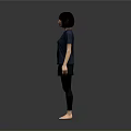 A Woman Standing Barefoot in Blue T-Shirt and Black Pants Against Gray Background