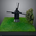 Black Windmill Model Display On Green Grass Base With Small Tree