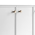 White Cabinet With Golden Base And Drawers Featuring Round Golden Handles