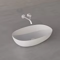 White Oval Shaped Washbasin With Silver Faucet On Gray Countertop