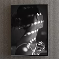 Black and White Portrait Painting of Female Profile With Circular Light Spots and Bun Hair