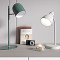 Modern Green And White Desk Lamps With Book Camera And Candle On Table