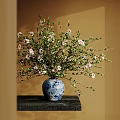 Blue And White Vase With White Flowers Green Leaves On Dark Table Against Warm Yellow Wall