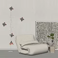 Single Sofa with Floor Lamp Circular Lampshades Black White Patterned Painting and Small Potted Plant