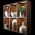 Stylish Ceramic Vases Arranged on Wooden Shelf with Brown White Patterns and Green Leaf