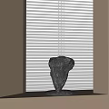 Modern Artistic Black Stone Sculpture Placed On Windowsill With White Blinds