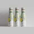 Three Bottles of Milk Beverage with Yellow Flowers Packaging Design on Light Background