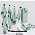 Light Green Towels Hanging On Hooks And Folded On White Countertop