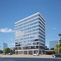 Modern High Rise Residential Building With Glass Windows Surrounded By Trees Cars And Blue Sky
