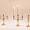 Brass Candle Holders With Three Two And Single Arms Holding White Candles