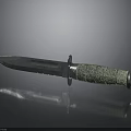 Tactical Combat Dagger With Green Textured Handle And Sharp Metal Blade On Reflective Surface