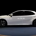 White Toyota Camry Sedan on Blue Display Stand with Black Background