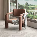 Single Seater Brown Sofa with Black and White Checkered Blanket by Window with Green View