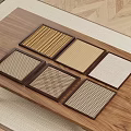 Square Coasters With Various Woven Textures Displayed On Wooden Tabletop