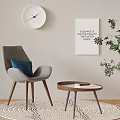Gray Accent Chair With Blue Cushion Round Wooden Side Table Art Print And Potted Plant