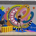 Colorful Art Mural Decorated Public Space With Archway And People Activities