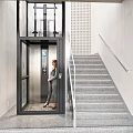 Modern Elevator Landing With Glass Elevator And Staircase