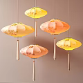 Colorful Hanging Lanterns With Floral Patterns And Tassels On Beige Background