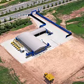 Aerial View Of Construction Site With Building Structure Construction Equipment Road And Green Trees