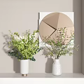 White Decorative Vases With Green Foliage And White Blossoms Near Modern Geometric Wall Art
