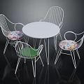 White Round Table With Four Metal Frame Chairs Featuring Colorful Cushions Furniture Set