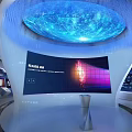 Modern Technology Exhibition Space With Circular Platform Blue Lighting And Digital Screens