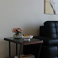 Sleek Modern Glass Top Side Table Beside Black Leather Sofa For Stylish Living Room Decor