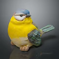 Small Bird Decorative Figurine With Blue Head Yellow Body And Green Wings