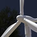 Wind Turbine Blades And Hub Structure Against Blue Sky With Clouds