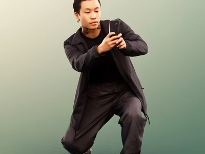 Man Crouching In Black Coat Holding Smartphone Against Green Background 3d model