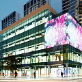 Modern Commercial Complex Featuring Glass Curtain Walls and Large Colorful LED Screen in Vibrant Night